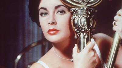 Cat On a Hot Tin Roof (1958) Woman holds onto gold pole looking ominously at camera