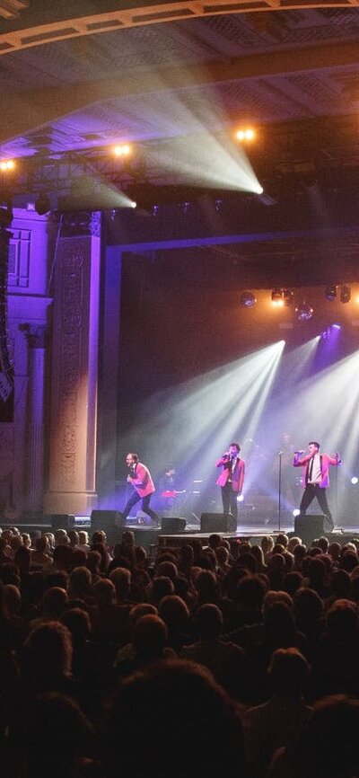 The 60 Four band performs to an enthralled theater audience.