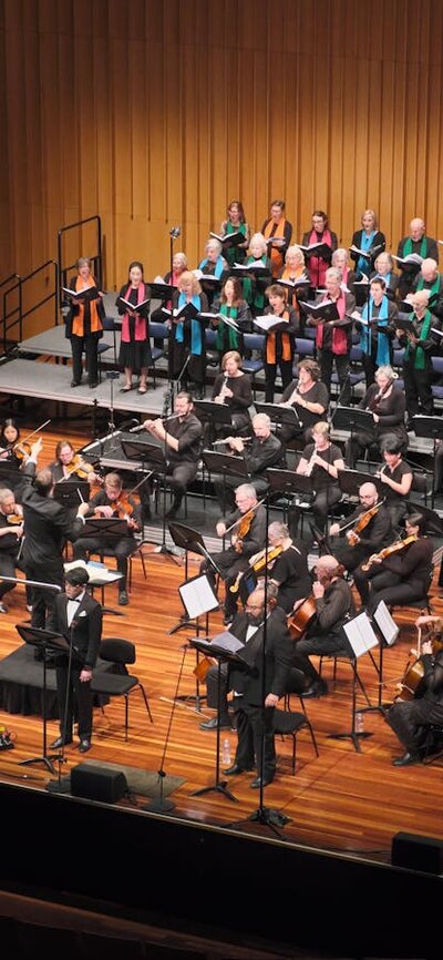 CCS & NCO Haydn The Seasons concert, Llewellyn Hall 1 April 2023 Soprano, tenor and bass soloists, conductor, orchestra and choir performing on stage.