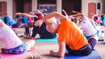 people doing yoga in bright clothes