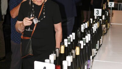 Lady looking at all the bottles of wine for tasting