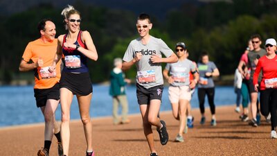 People running and smiling towards the camera