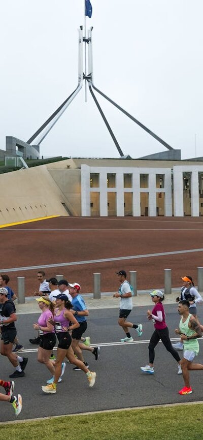 Participants running past New Parliament House