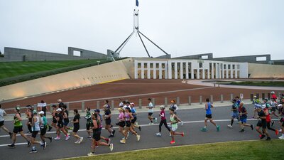 Participants running past New Parliament House