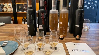Octomore bottles behind whisky glasses containing whisky