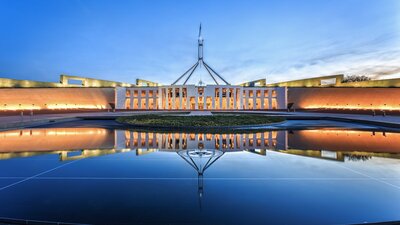 Photo of Australian Parliament House in the evening.