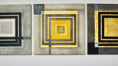 A triptych of abstract printed artworks with motifs of squares.