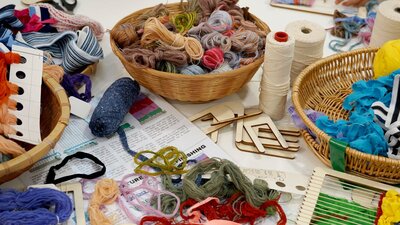 A table covered in weaving equipment and yarn