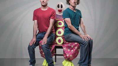 Umbilical Brothers Umbilical Brothers sitting on the lap of a clown called Roadie, looking uncomfortable