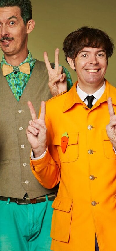 The Vegtable Plot making peace signs with their hands