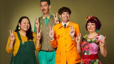 The Vegtable Plot making peace signs with their hands