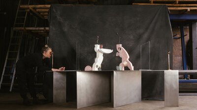 Sanne Mestrom in studio with A fractured gaze, 2025 A photograph of a woman looking through a viewfinder, drawing the abstract sculptures she sees.