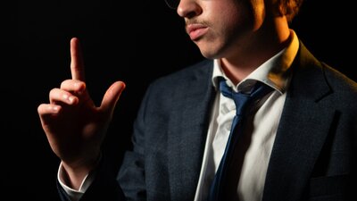 Man looks at finger, worried and tired