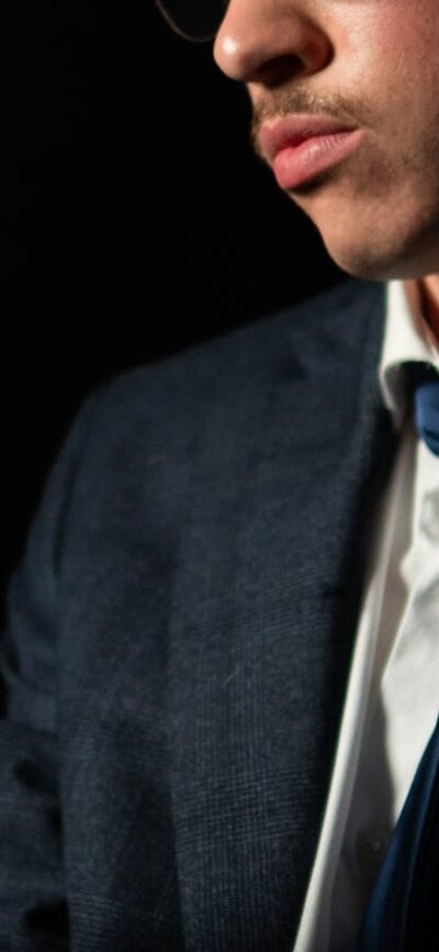 Thom Pain Man looks at finger, worried and tired