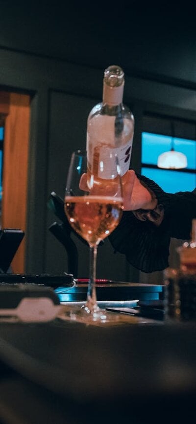 Bartender pouring glass of wine