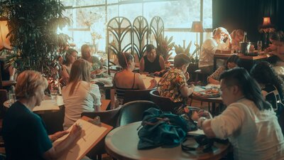 People sitting at tables drawing