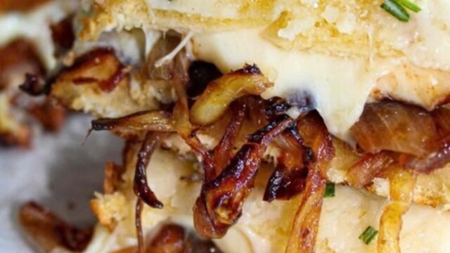 Golden toasted sandwich with melted cheese, caramelised onions and mushrooms, topped with chives.