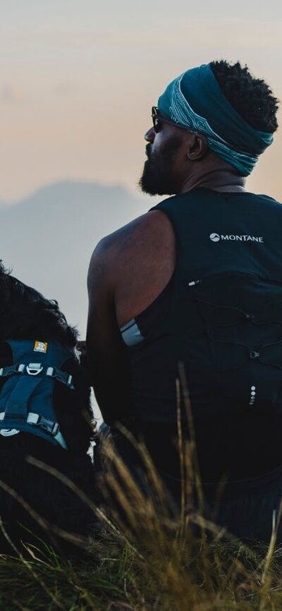 Top Dog Film Festival World Tour 2026 Back of man and his dog both looking left with beautiful scenery in the background