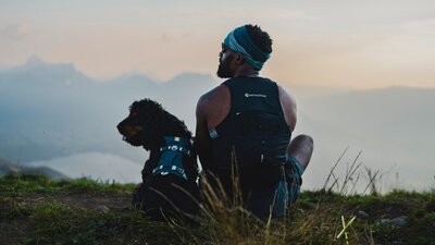 Top Dog Film Festival World Tour 2026 Back of man and his dog both looking left with beautiful scenery in the background
