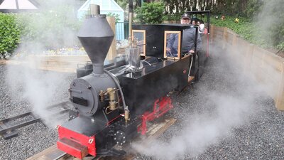 Steam is coming out of the miniature steam train