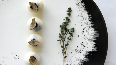 Plated dish featuring truffle and rosemary
