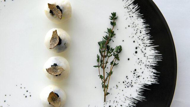 Plated dish featuring truffle and rosemary