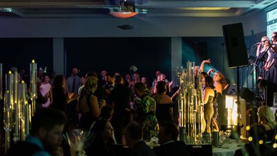 People dancing in room, lights and smiling