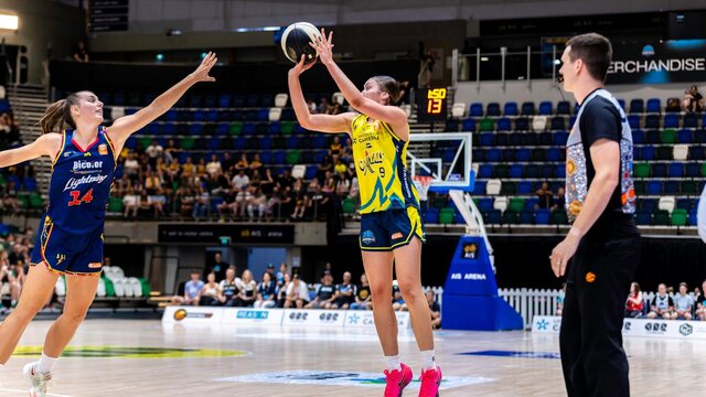 UC Capitals player shooting the basketball while a defender closes in.