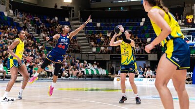 UC Capitals player shooting the basketball while a defender closes in.
