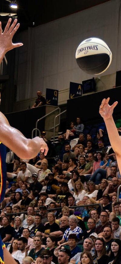 UC Capitals player shooting the basketball while a defender closes in.