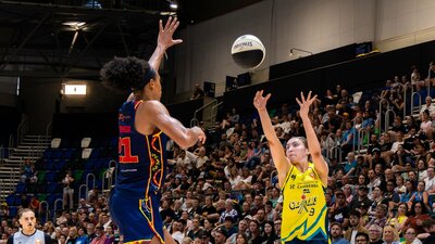 UC Capitals player shooting the basketball while a defender closes in.