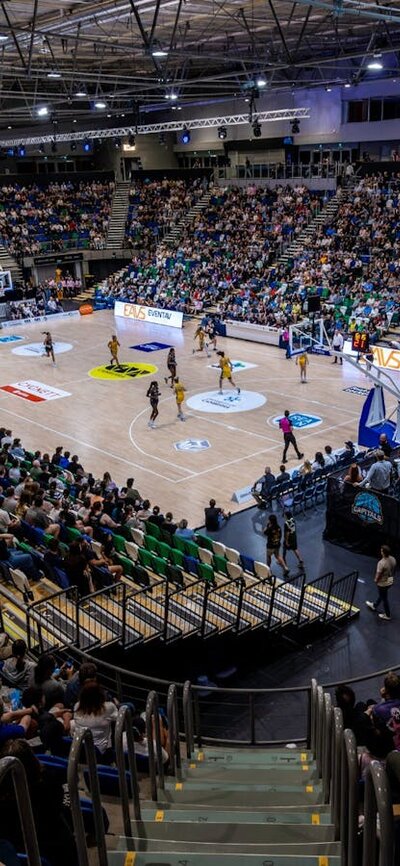 A full arena watching a UC Capitals game from the stands.