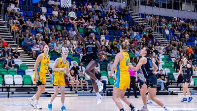 UC Capitals player driving to the basket for a layup during a WNBL game.