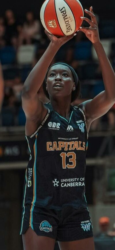 Basketball player in motion of shooting a basketball.