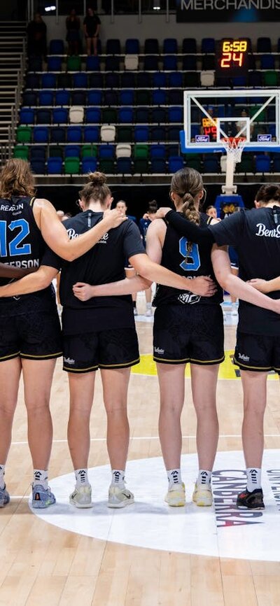 UC Capitals stand in a line after their names are called before the start of a game.