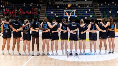 UC Capitals stand in a line after their names are called before the start of a game.