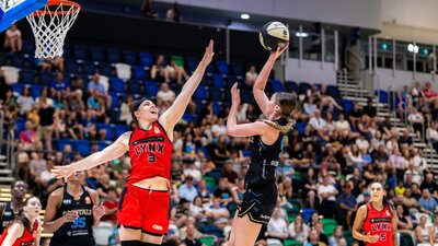 UC Capitals player shooting the basketball while a defender closes in.
