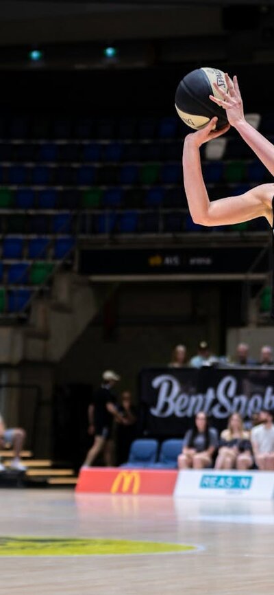 UC Capitals player shooting the basketball while a defender closes in.