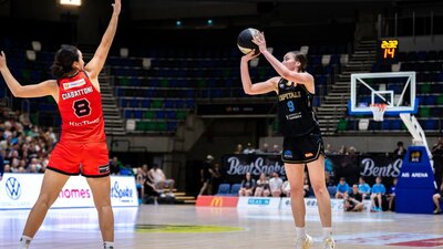 UC Capitals player shooting the basketball while a defender closes in.