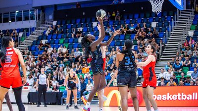 UC Capitals player driving to the basket for a layup during a WNBL game against Perth Lynx.
