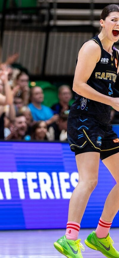 UC Capitals player celebrates on the court after scoring.