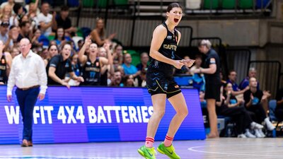 UC Capitals player celebrates on the court after scoring.