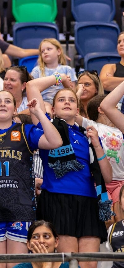 UC Capitals fans cheering in the stands.