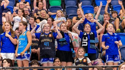 UC Capitals fans cheering in the stands.