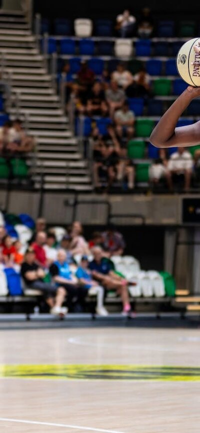 UC Capitals player shooting the basketball while a defender closes in.