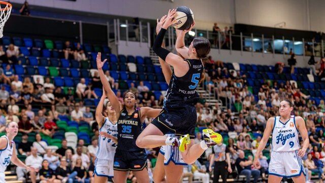 UC Capitals player shooting the basketball while a defender closes in.