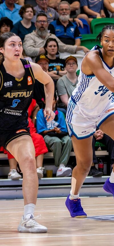 UC Capitals player driving to the basket to complete a layup.