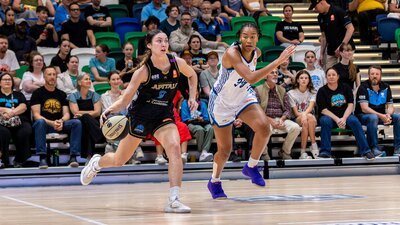 UC Capitals player driving to the basket to complete a layup.