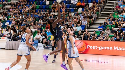 UC Capitals player driving to the basket for a layup during a WNBL game.