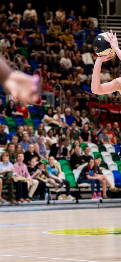 UC Capitals player shooting the basketball while a defender closes in.